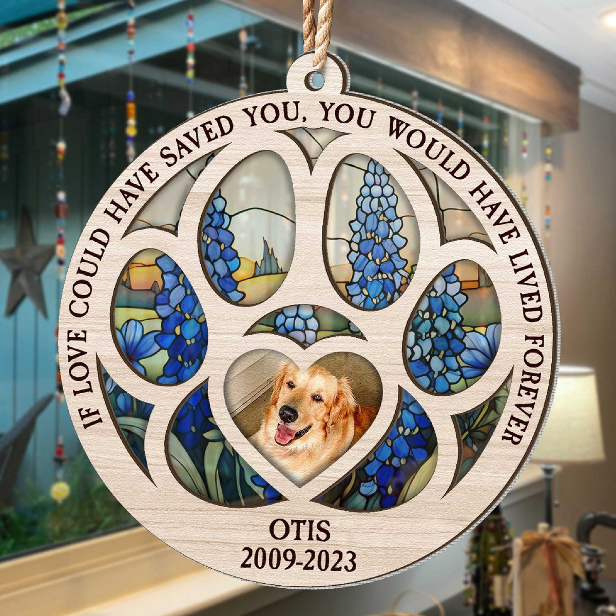 Paw shaped suncatcher hanging in a window