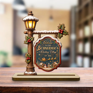 Personalized Christmas village wood plaque on a table